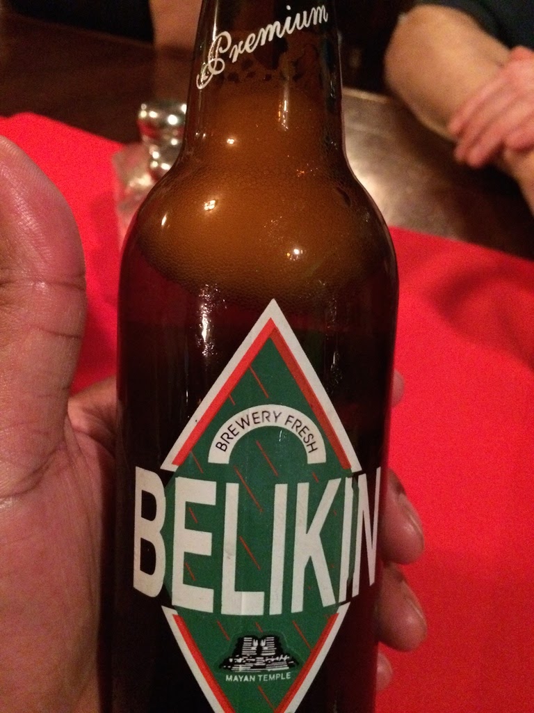 belikin beer in hand